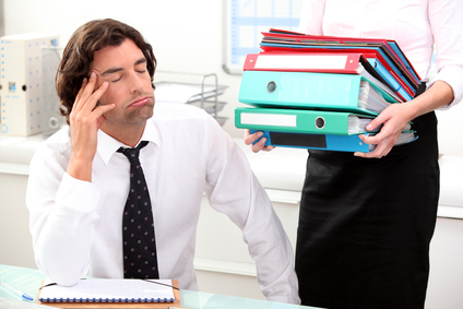 Office worker overwhelmed by load of work